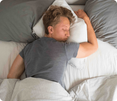 Müder Mann liegt im Bett